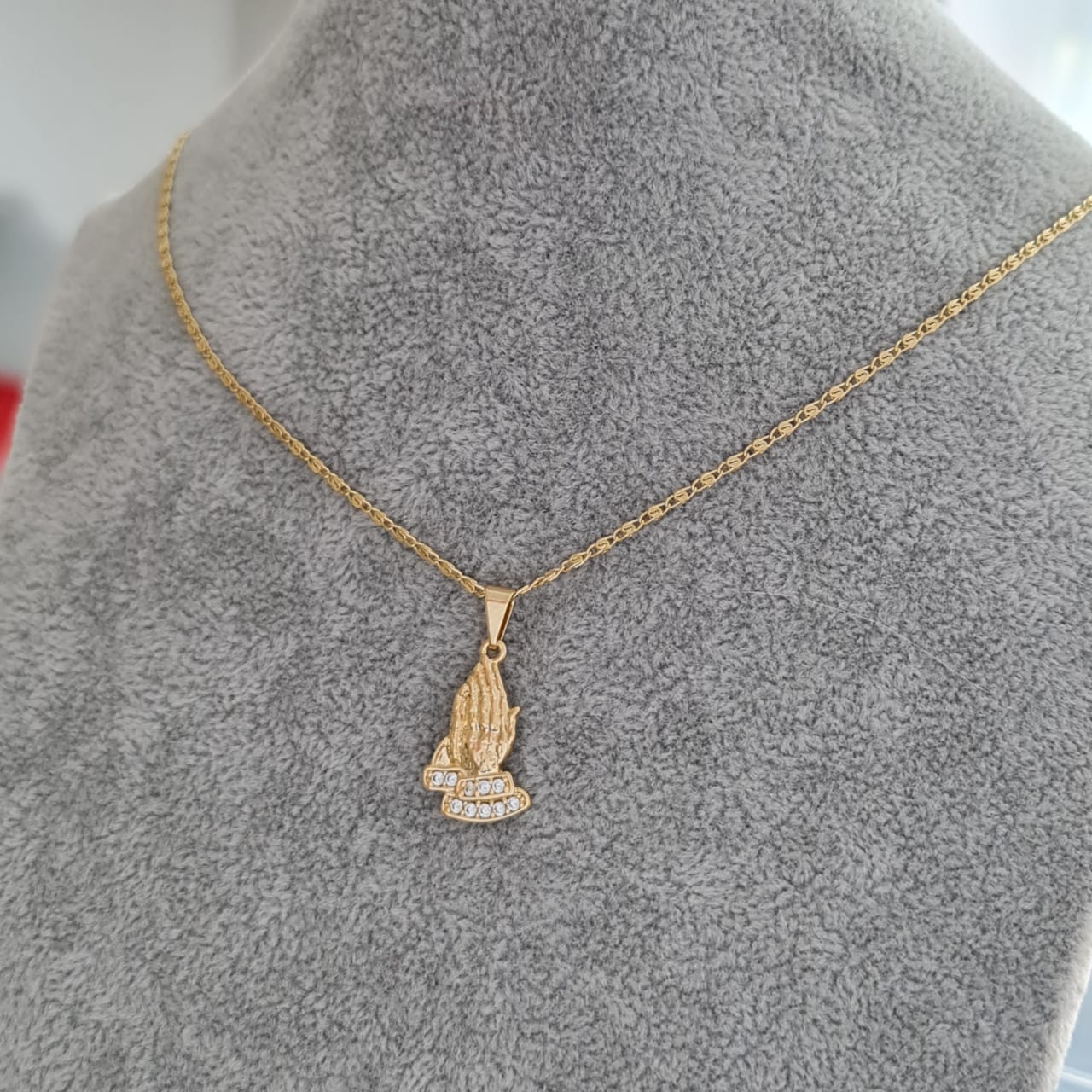 dije manos de oración
