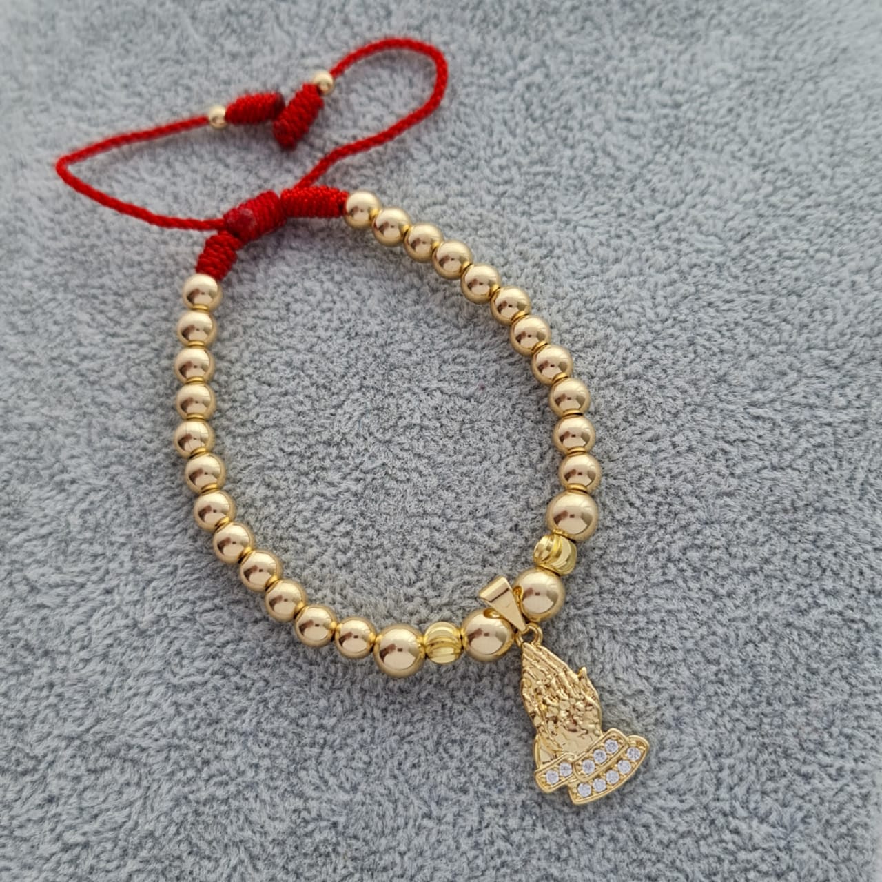 dije manos de oración
